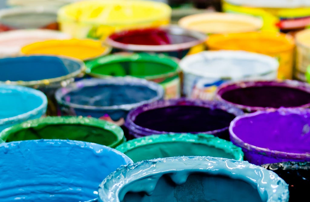 Assorted colorful paint buckets viewed from above
